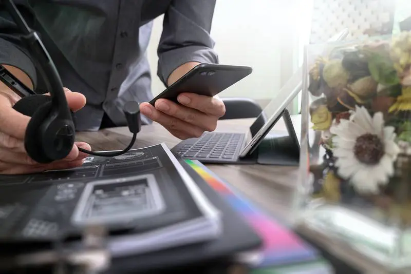 Man using VOIP headset with digital tablet computer docking keyb